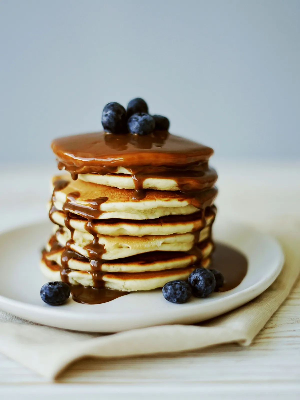 Pancakes with homemade coffee flavored syrup and blueberries