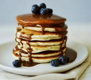 Pancakes with homemade coffee flavored syrup and blueberries